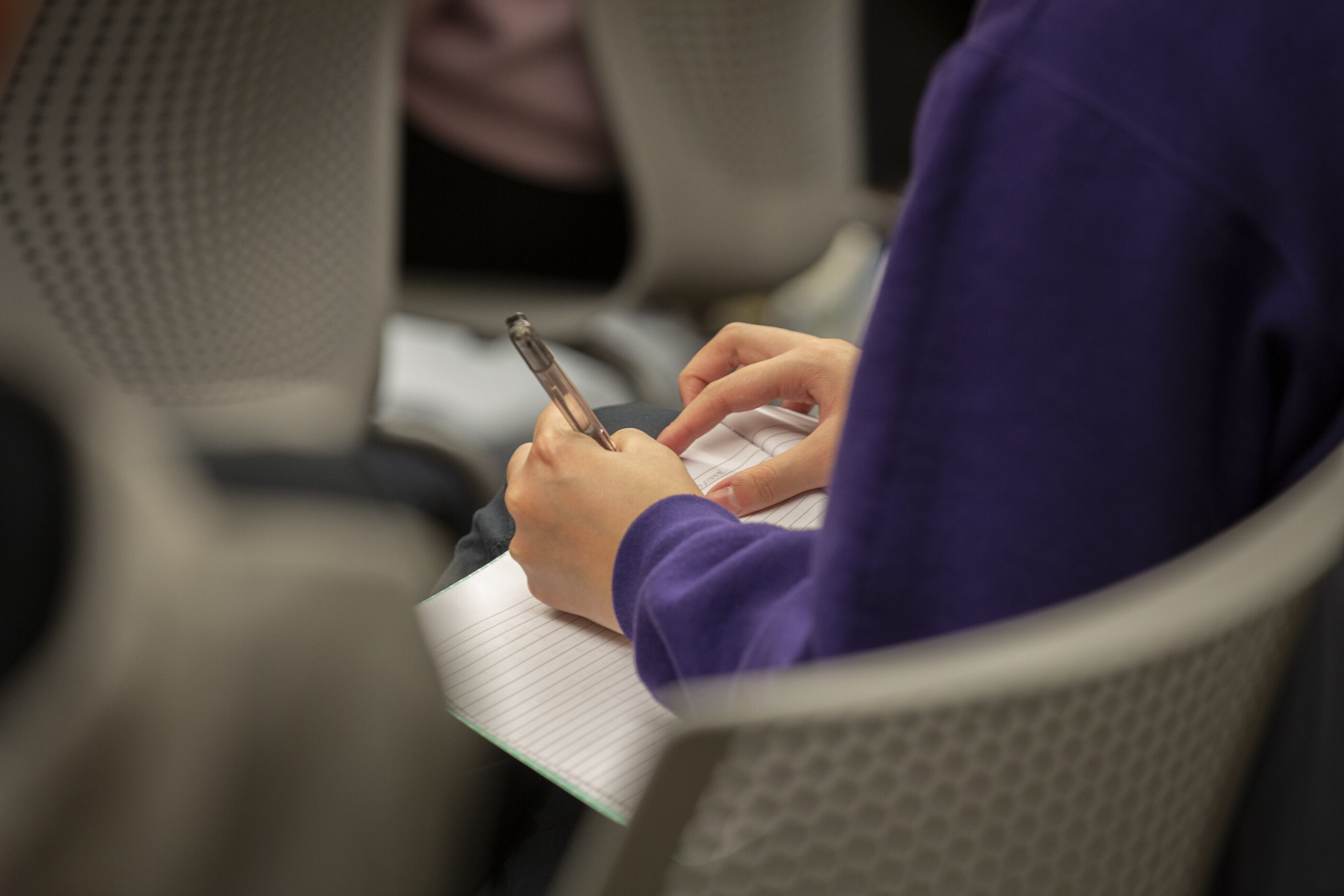 Person writing in notebook