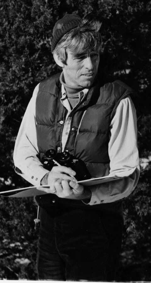 Paul Catts holds a piece of paper and binoculars.