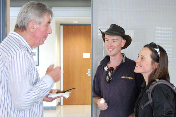 The lecturer speaks to two students.