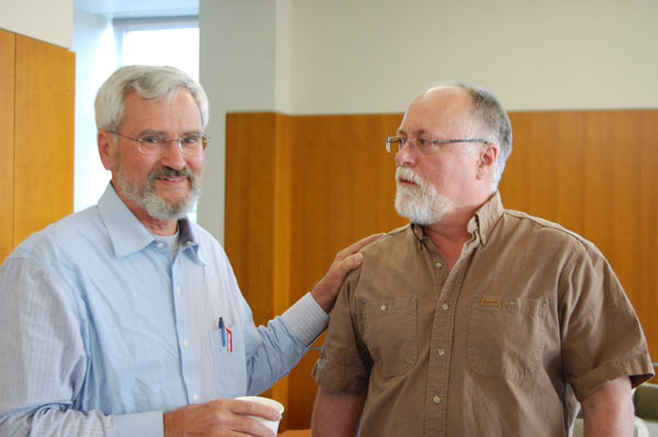 A man rests a hand on Dr. Shepphard.