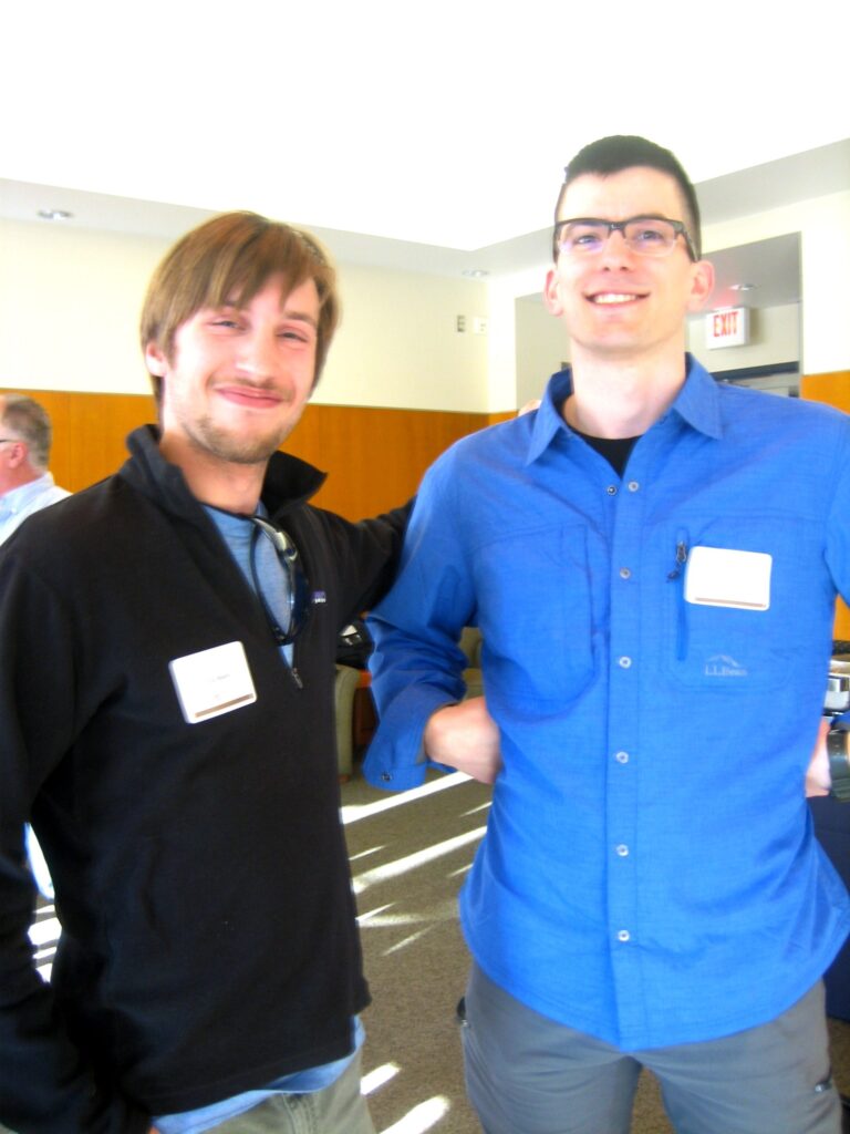 Two people stand together and smile for a picture.