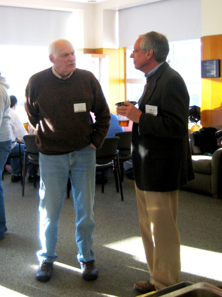 Two men talk to each other.