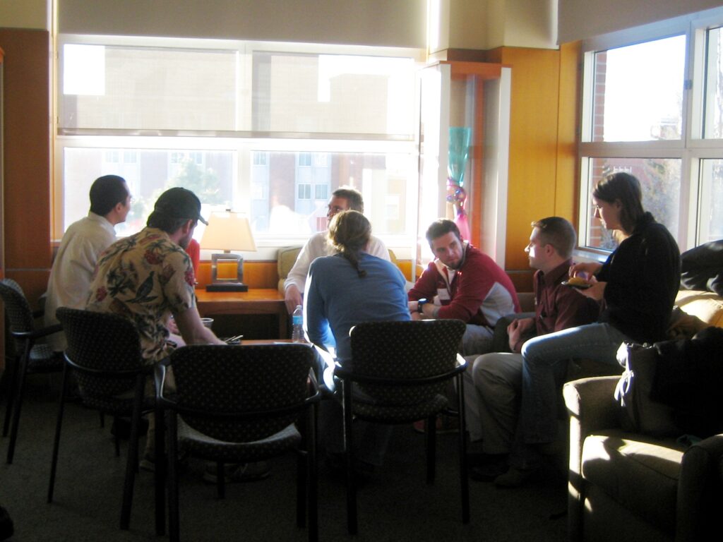 People are seated together, talking amongst themselves.