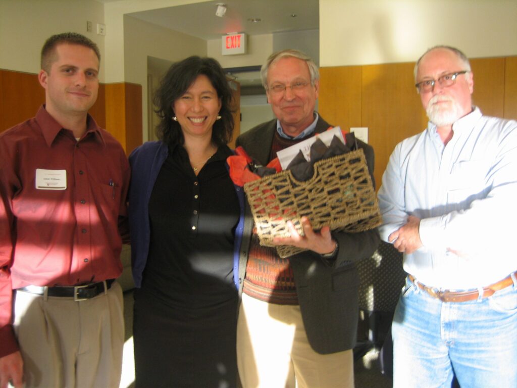 Laura Lavine stands next to Dr. Nijjout, who holds onto a basket.