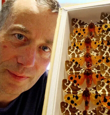 Lars Crabo with boxes of butterflies.