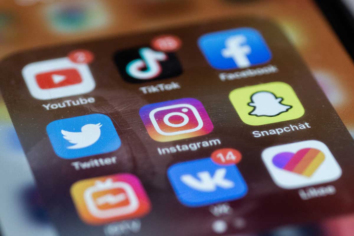 Social media apps on a smartphone screen.