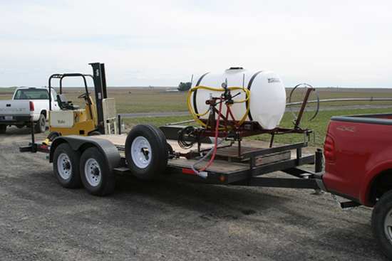 A picture of a three point sprayer on the back of a 17 foot trailer.