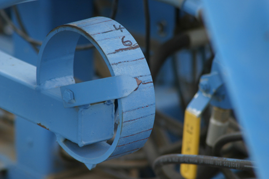 A picture of an adjustable planting depth indicator on a small plot potato planter.
