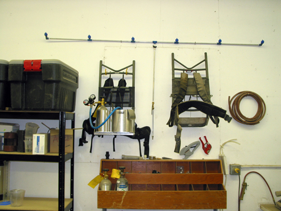 A picture of two back pack sprayers and a boom.