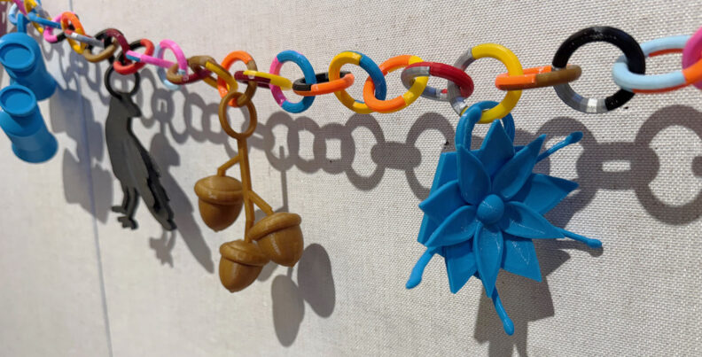 Student 3D work hanging in gallery.