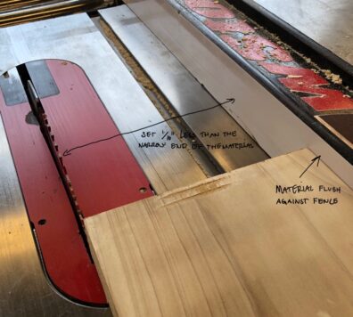 A board positioned on the table saw between the fence and the blade. Image links to larger version.