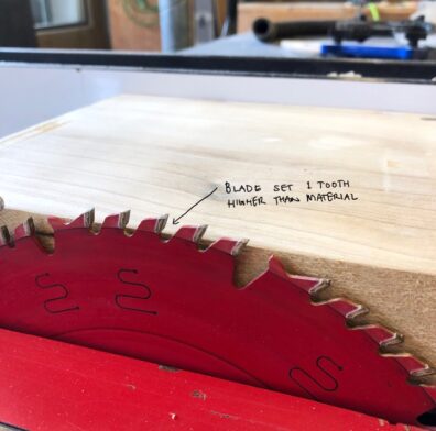 Photo showing a circular saw blade set one tooth higher than the material. Image links to larger version.