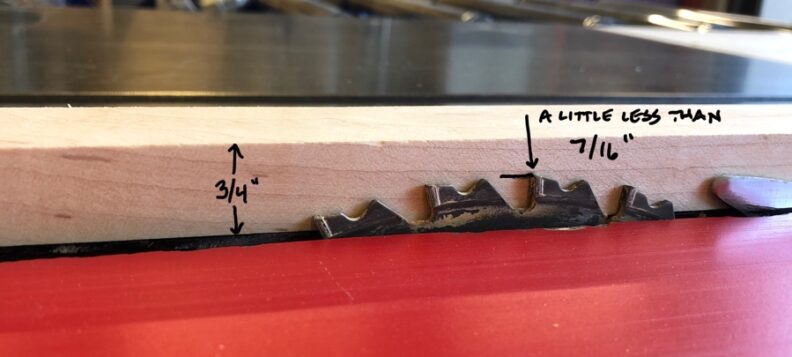 Photo showing the circular blade of the table saw set a little less than 7/16 inches from the top side of a 3/4 inch material. Image links to larger version.