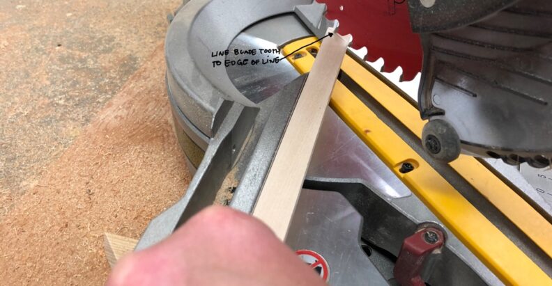 Closeup of the miter saw cut. Instructions to line the blade tooth with the edge of the line. Image links to larger version.