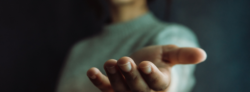 Person holding out their hand toward the camera.
