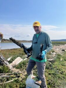 image of volunteer holding firework beach litter
