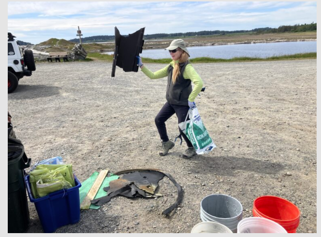 Beach litter cleanup Volunteer displaying some of the items that have collected from the beach.