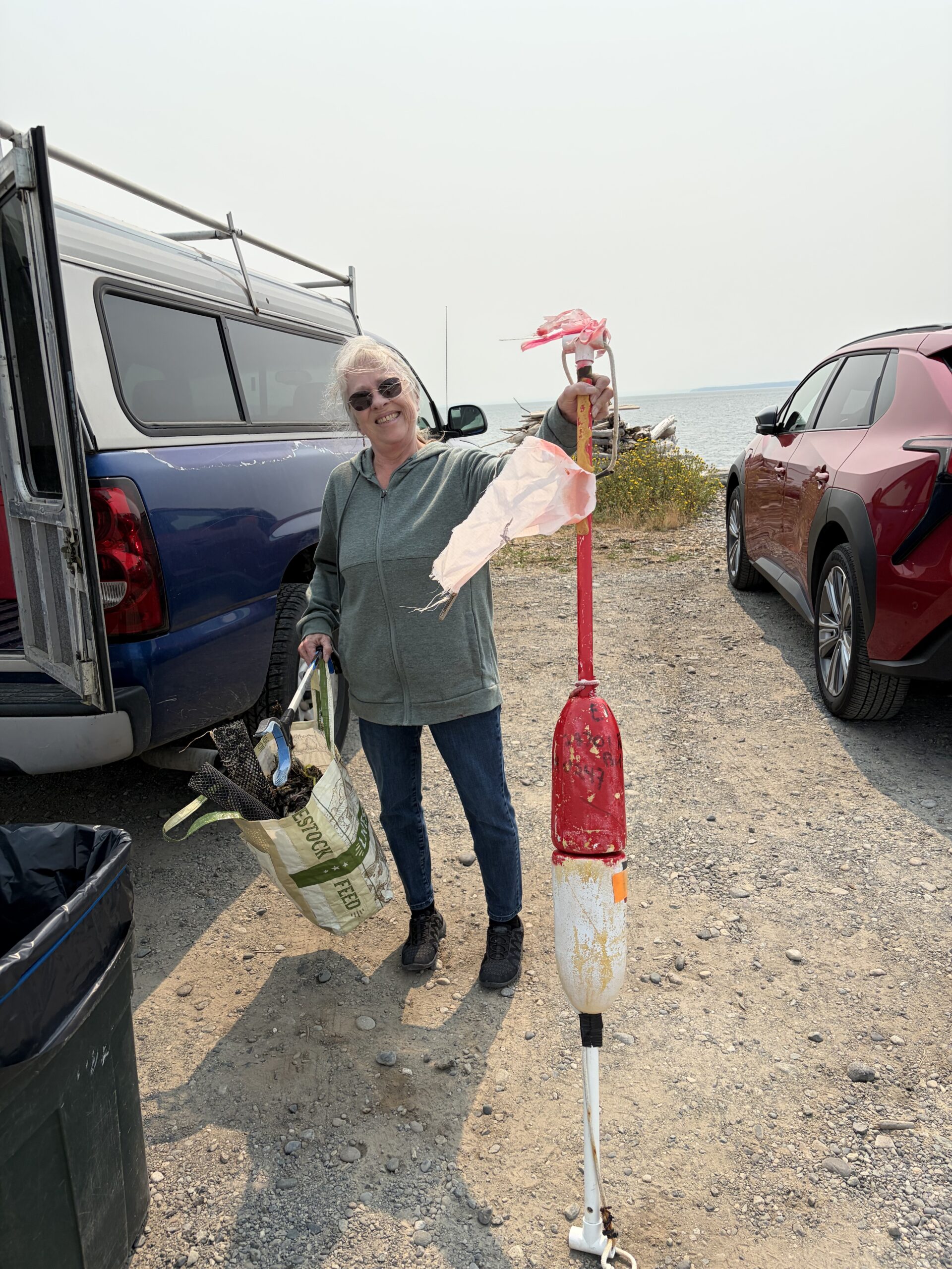Photo image of person holding beach litter collected from beach