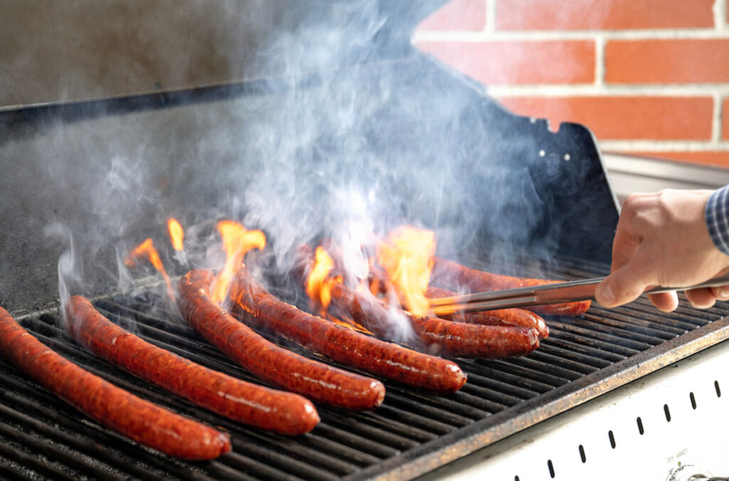Cooking sausages on the grill