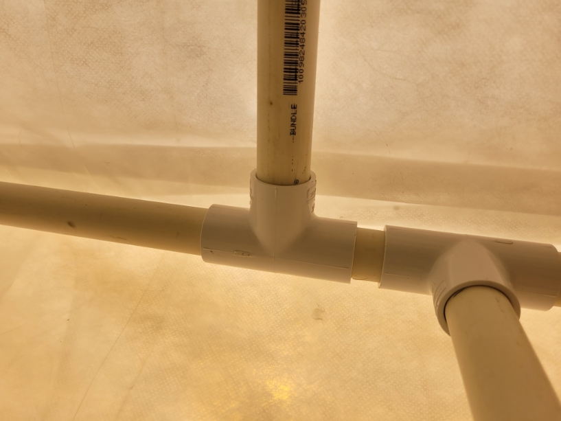 One main PVC pipe with two off-jetting pipes attached with three-way plumbing tees.