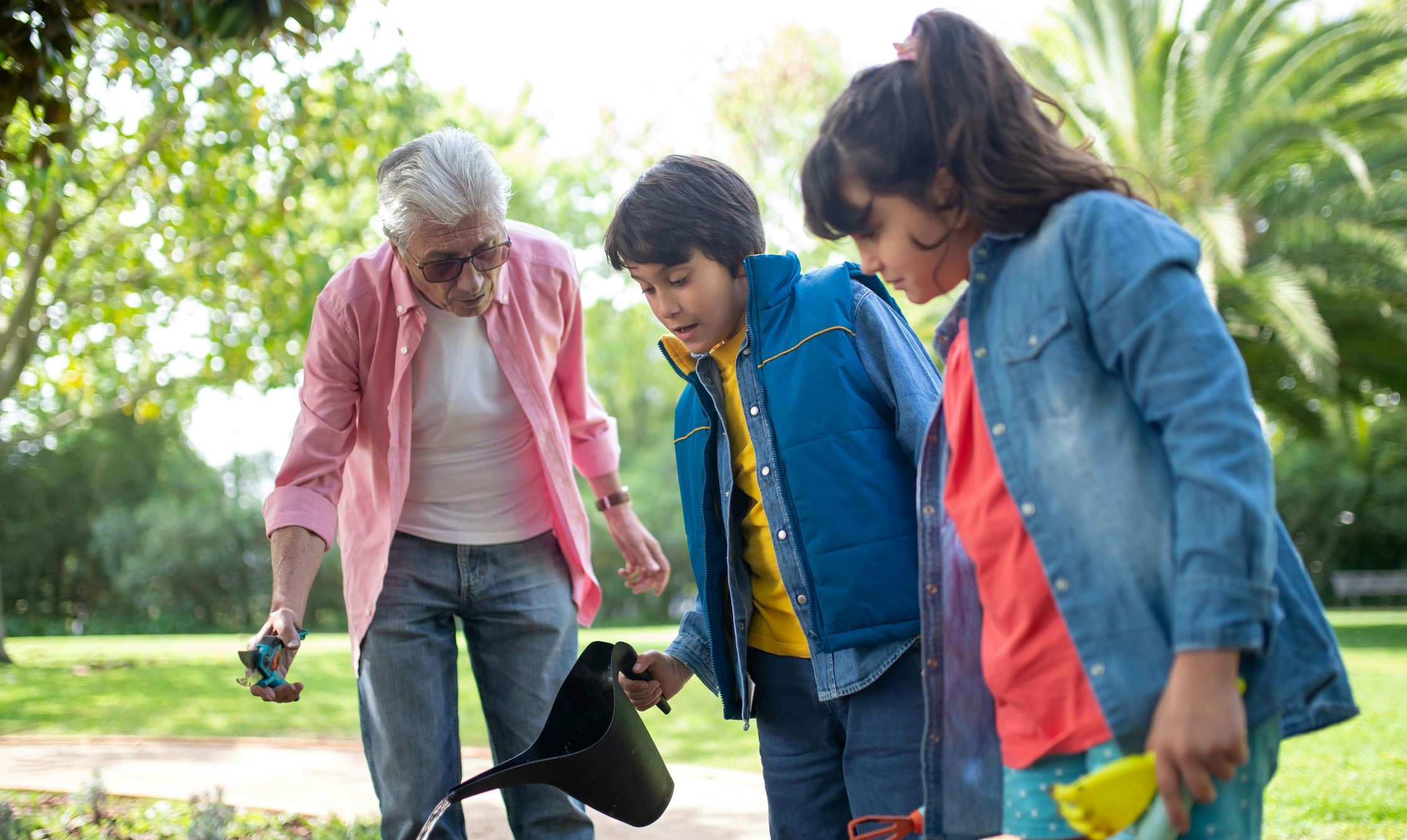 adult teaching youth about gardening