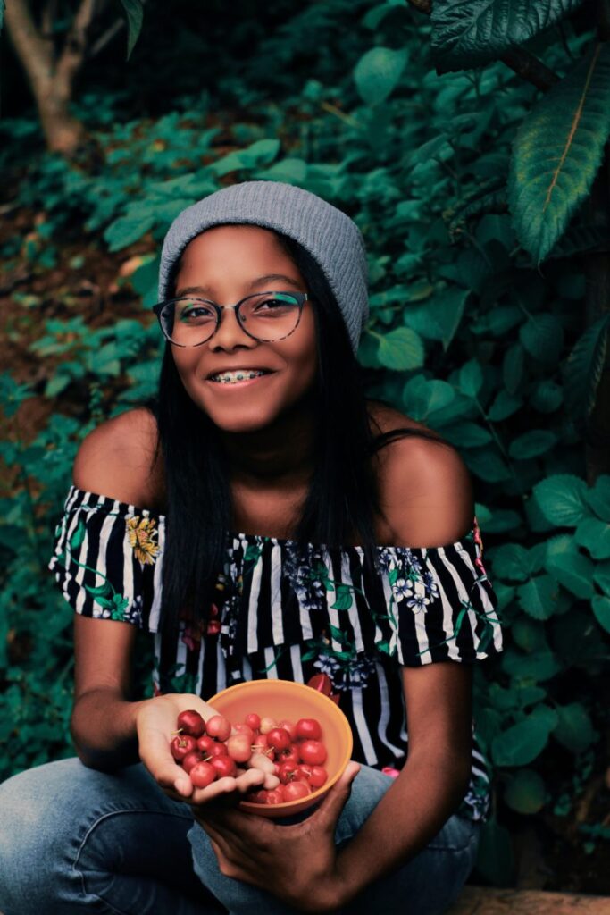 Girl with bowl of cherries