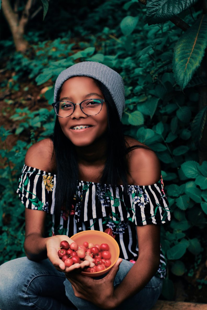 Girl with bowl of cherries