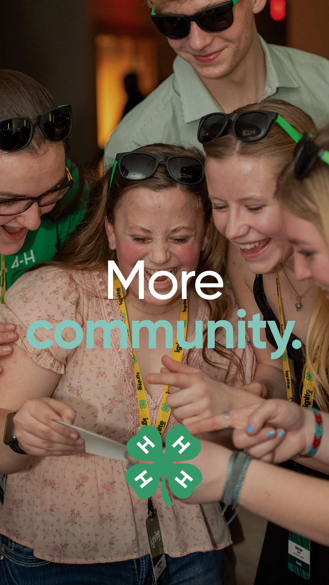 Image of 4 youth gathered around and smiling and laughng with text in front that says More Community. and a 4-H logo