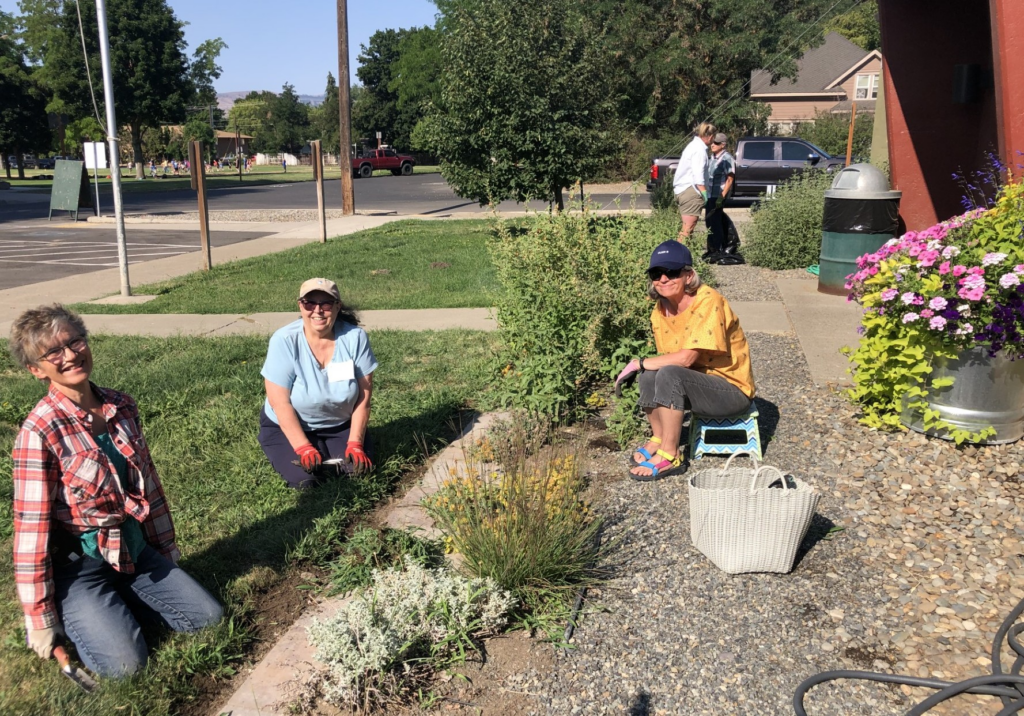 Master gardeners working in a garden of fire resistant plants