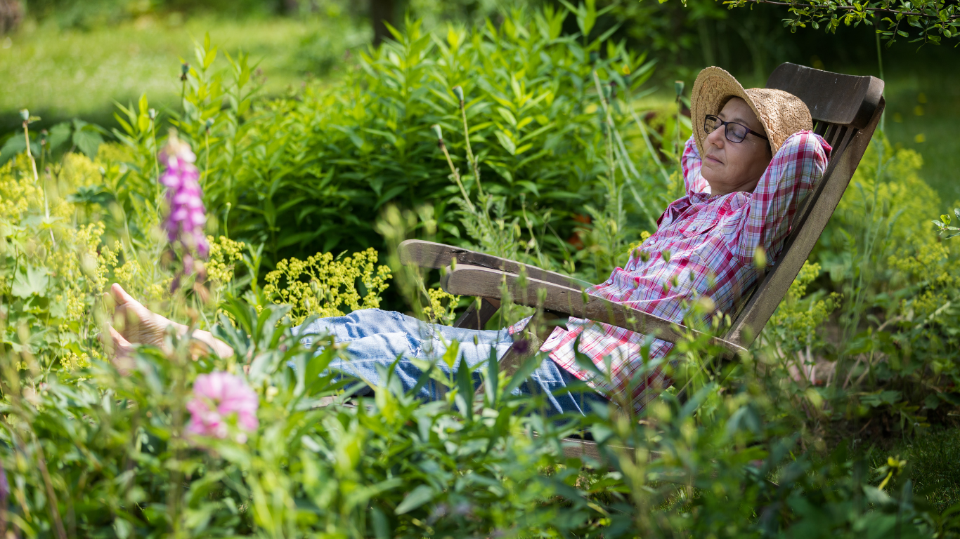 Woman relaxing in her garden.