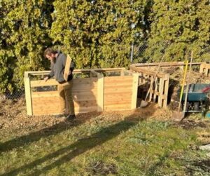 Man building a compost bin