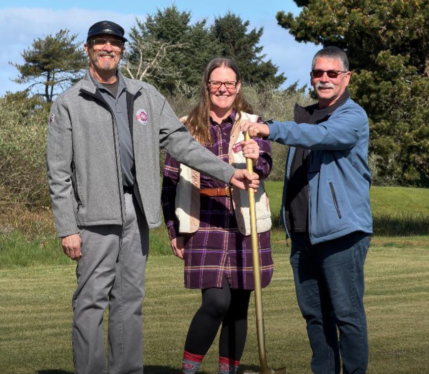 Two men and a woman at a groundbreaking ceremony.