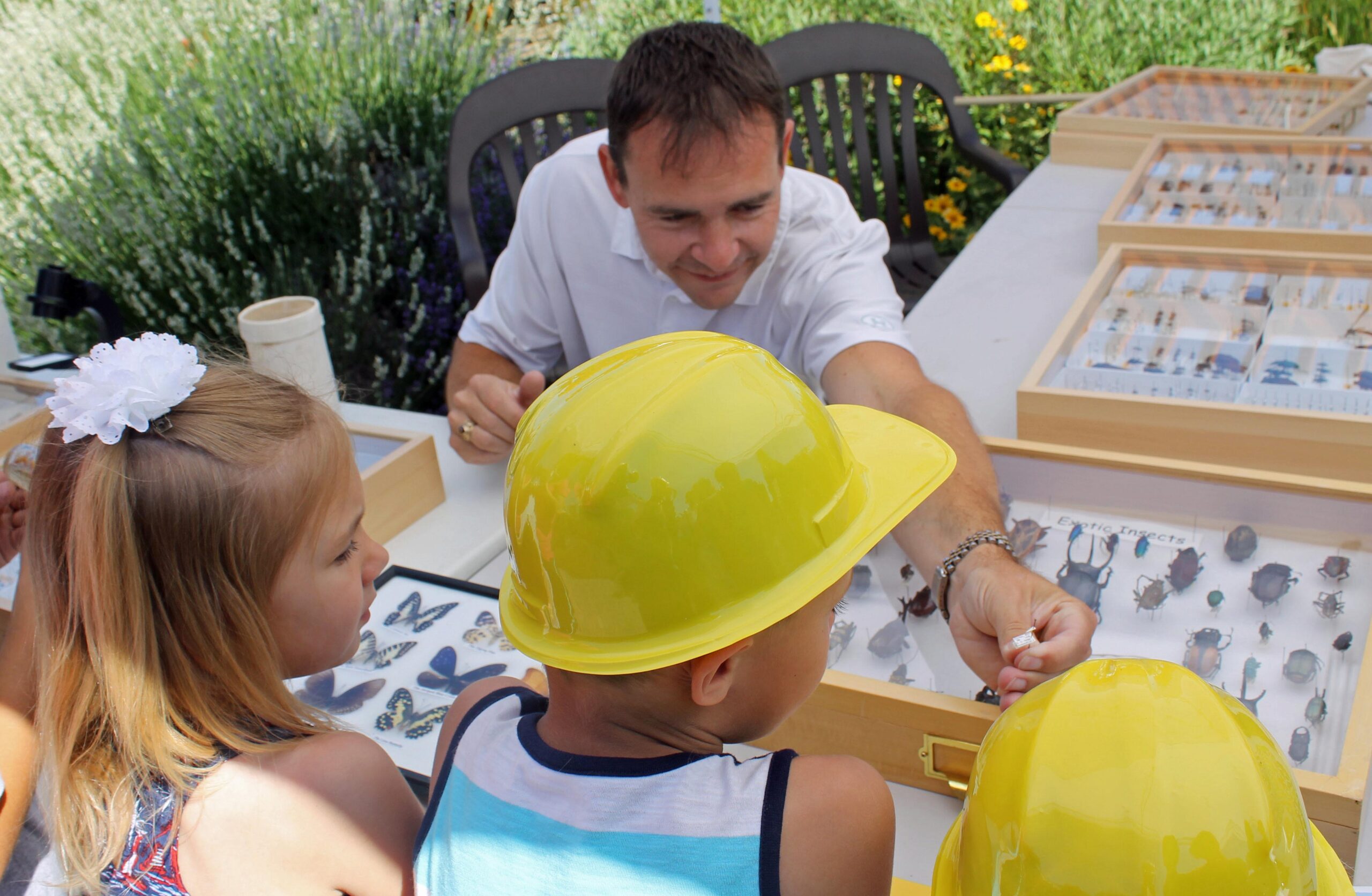Man teaching kids about insects.