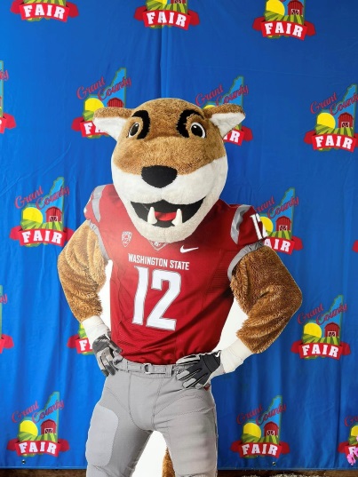 Mascot Butch poses in front of a blue Grant County Fair backdrop, while attending the Grant County Fair in August this year, 2024. 