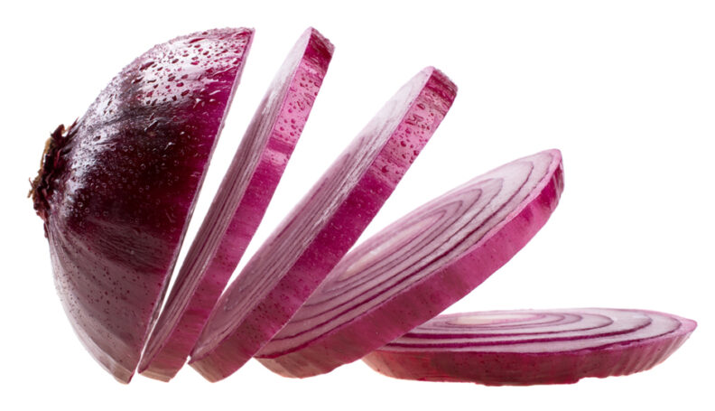 Decoarative. An image of a red onione that has been perfectly sliced into 5 pieces. The left end of the onion is larger and displays the small remnants of the onion's roots.                          






















































