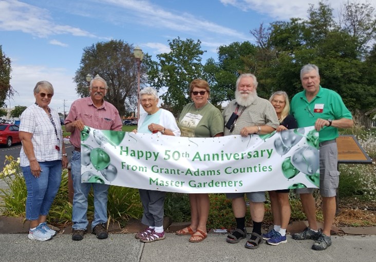 Master Gardeners holding a 50th anniversary banner