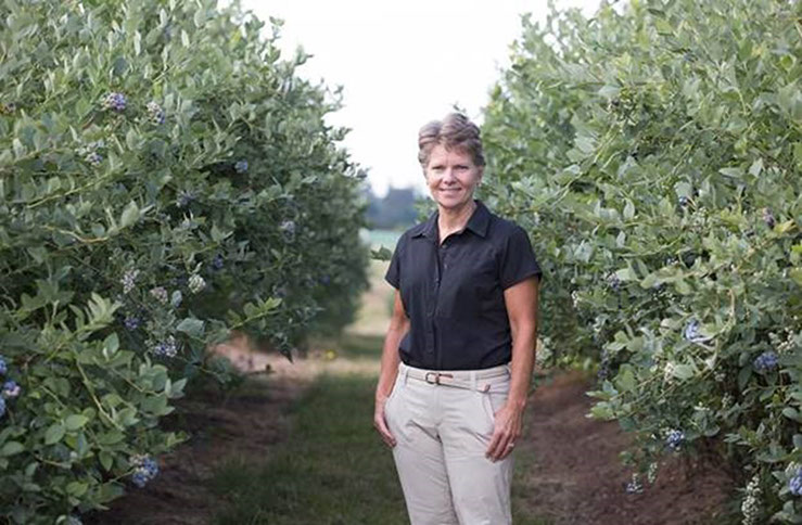 Photo of Dr. Bernadine Strik in a blueberry grove