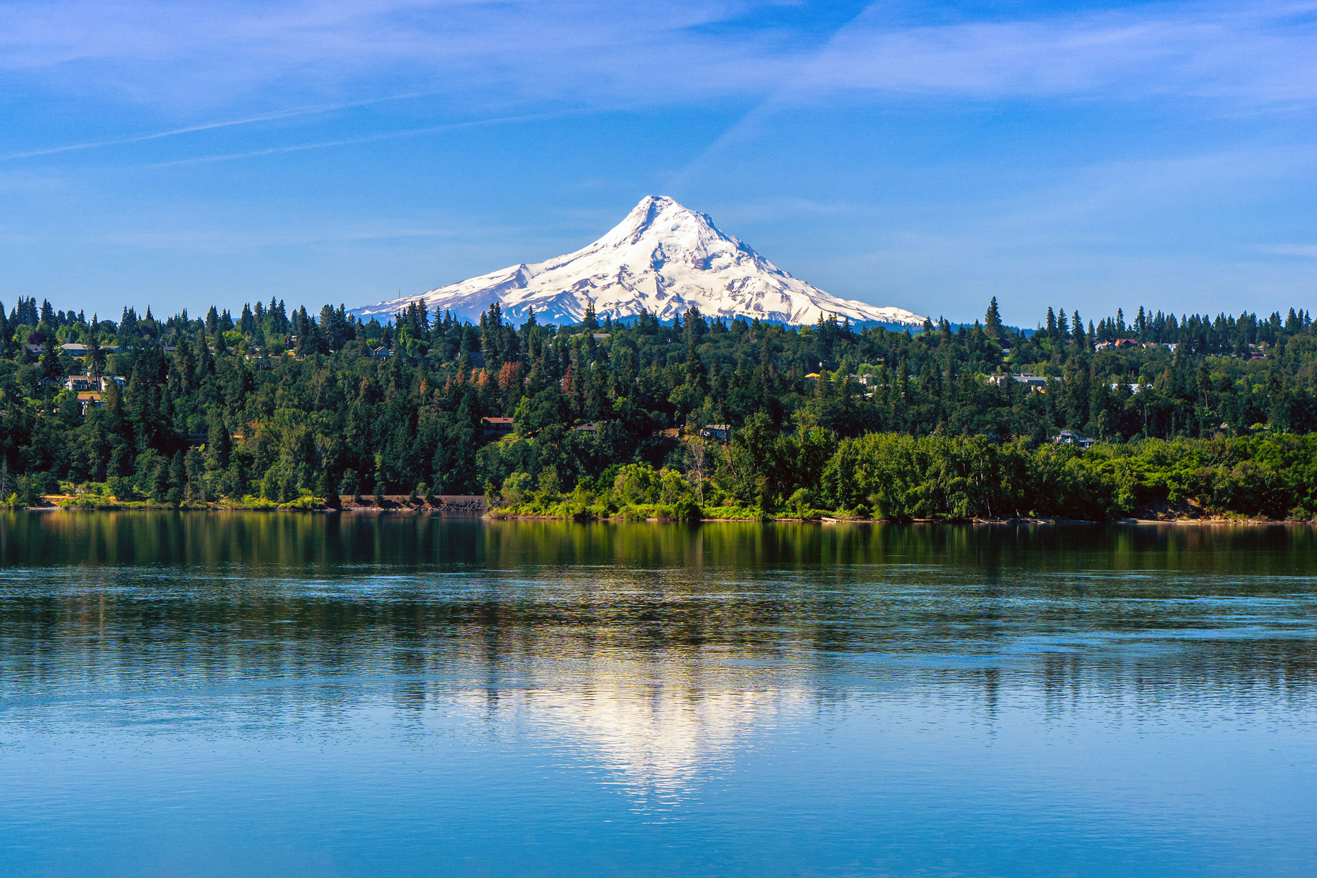 Mt Hood covered with snow over Hood River and reflecting on the Columbia River, Oregon. Shot taken from Washington state. USA.
