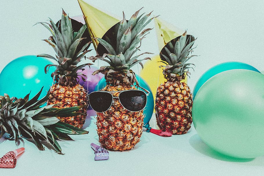 pineapples wearing sunglasses with balloons