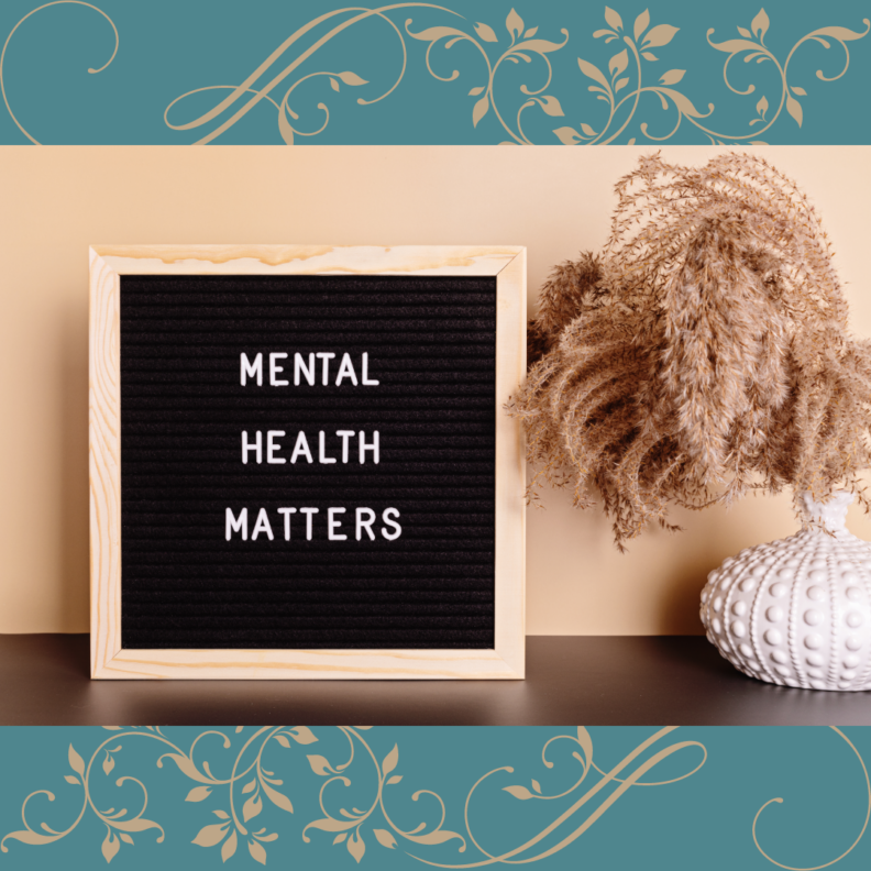 Desktop sign saying "mental health matters" against a light wall with decorative grass in a vase to the right. On a sage green background with tan floral flourishes.