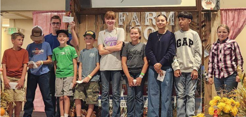 A group of ten youth indoors at fair.