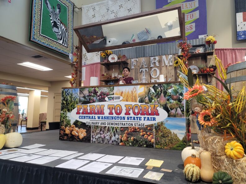 Boy speaking into a microphone while on the Farm to Fork Stage.