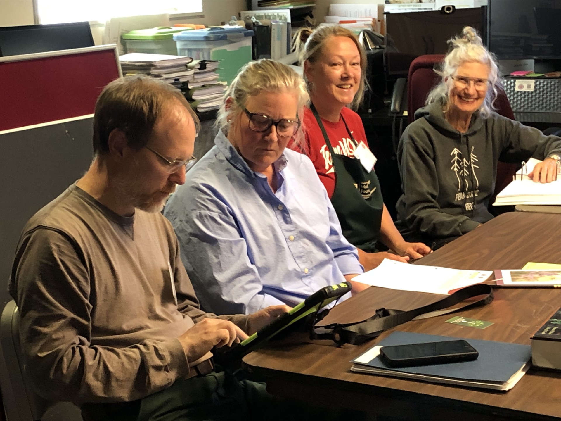 Two master gardeners moving compost.