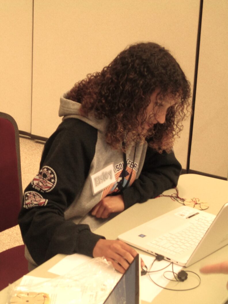 A youth member working on the computer for the cricut workshop.
