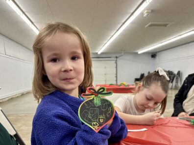 Youth member scratched off paper ornaments and they turned colorful.