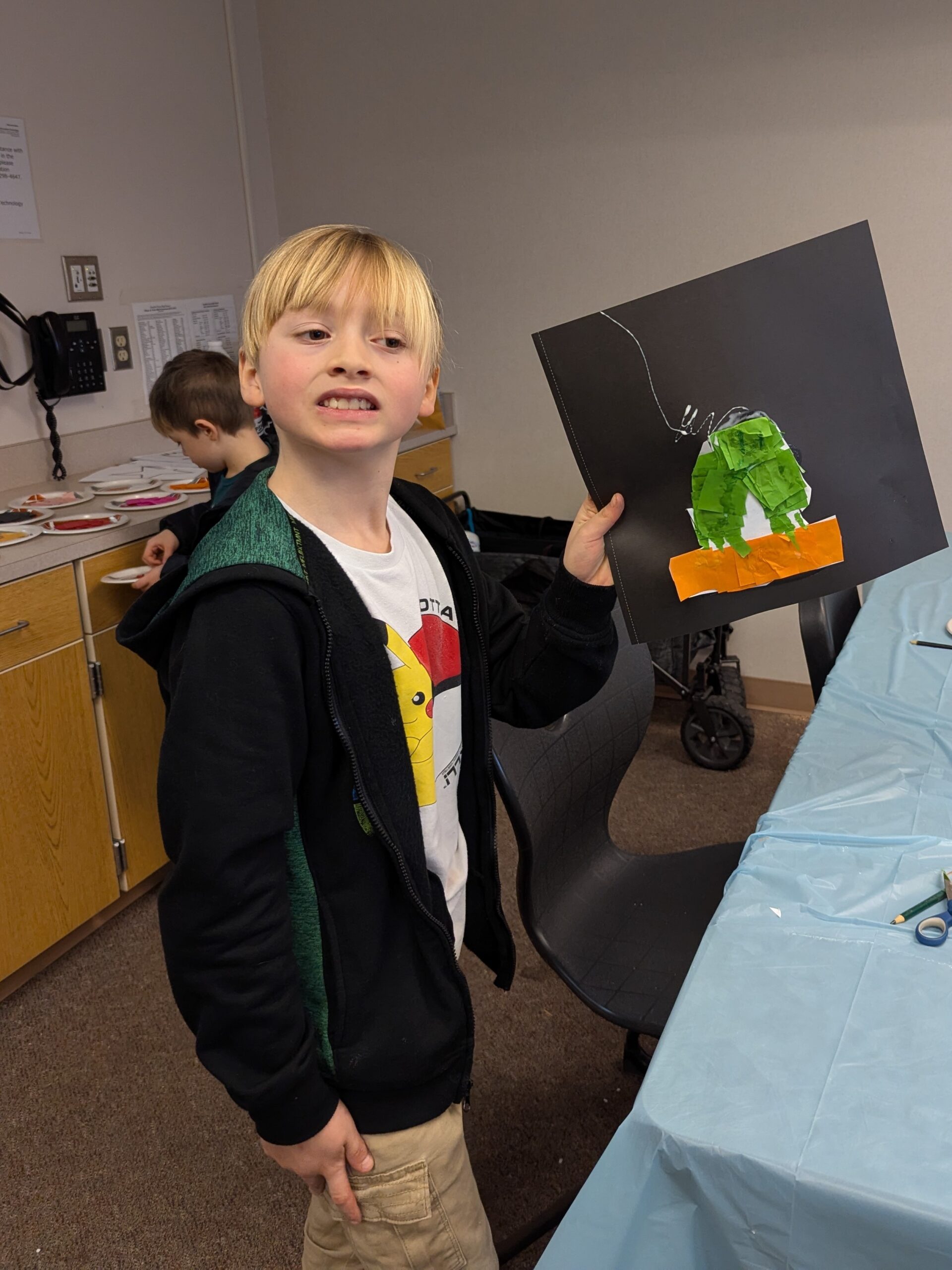 Youth member showing his project at Super Saturday.