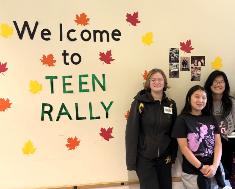 3 youth members standing in front of a Welcome to Teen Rally
