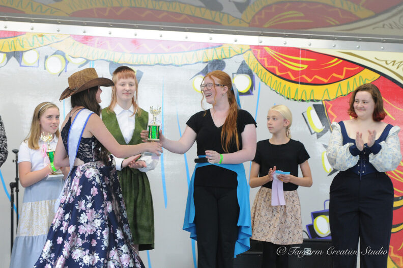 Youth receiving awards for sewing