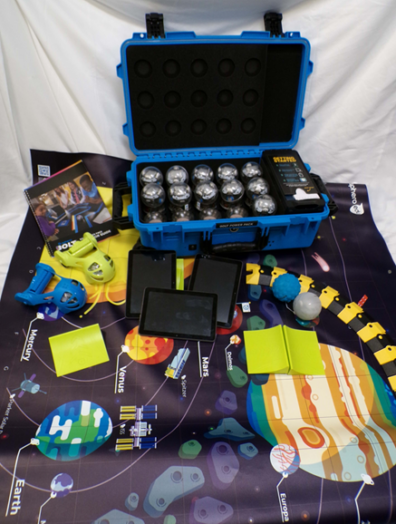 The contents of the Spheros STEM kit layed out on a solar system mat.