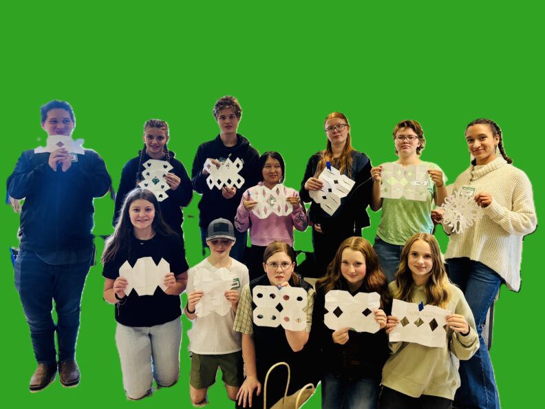 Picture of the youth at teen rally - holding snowflakes they made. They are all different - just like the youth holding them.